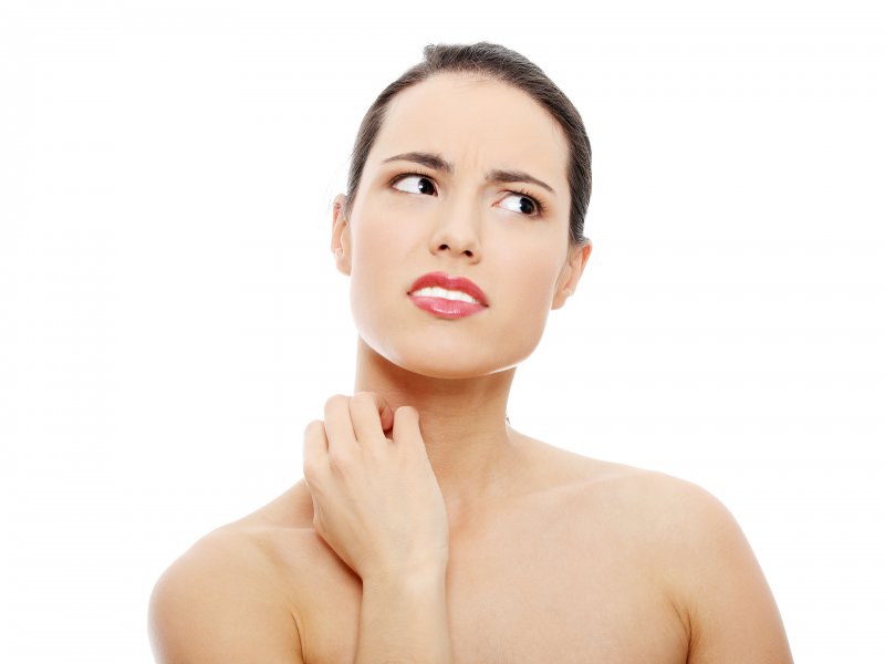 Kobieta zmagająca się z bólem w szyi